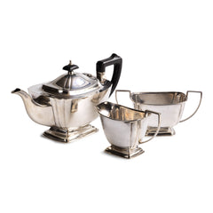 A classic 1930s Regency style silver plated three piece afternoon tea set, consisting of a teapot, milk jug and a twin-handled sugar basin. The teapot has a black Bakelite handle and knop to its lid, and each piece is stamped "EPNS 1285 D&P". Delivers approximately six cups of piping hot tea.