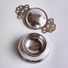Antique silver plated tea strainer with stand