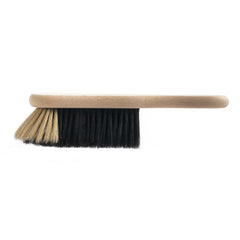A traditional bannister brush, also known as a dustpan brush, and handmade in the UK by one of our last surviving brush makers. Crafted from beechwood and two-tone horsehair, the splayed bristles are designed to coax dirt from awkward spaces.