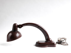 A rare Sigma Bakelite desk lamp designed in the 1940s by Christian Dell at the Bauhaus, Germany, for manufacturer Heinrich Römmler. It has a pivoting arm and adjustable shade for directional lighting, making it ideal for the desk or the bedside table. Constructed of deep chocolate brown Bakelite, it has an on/off switch, and is rewired with cloth covered electrical cable.