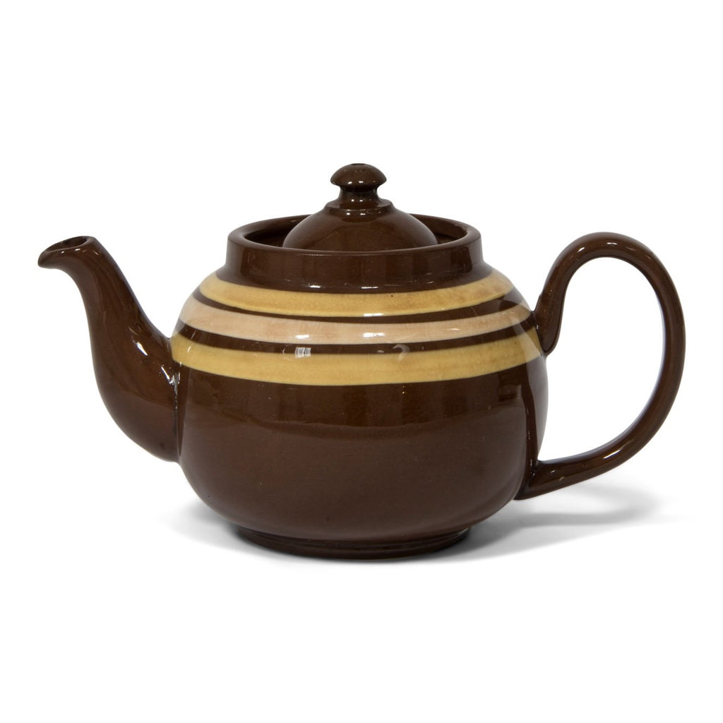 An original vintage 4 cup Brown Betty teapot with custard coloured banding and a very comfy big grip handle. Original Brown Betty teapots are distinguished by two common characteristics: their red Etruria Marl clay, and a rich brown manganese glaze known as Rockingham, unique to Stoke-on-Trent, Staffordshire, UK.
