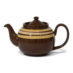 An original vintage 4 cup Brown Betty teapot with custard coloured banding and a very comfy big grip handle. Original Brown Betty teapots are distinguished by two common characteristics: their red Etruria Marl clay, and a rich brown manganese glaze known as Rockingham, unique to Stoke-on-Trent, Staffordshire, UK.