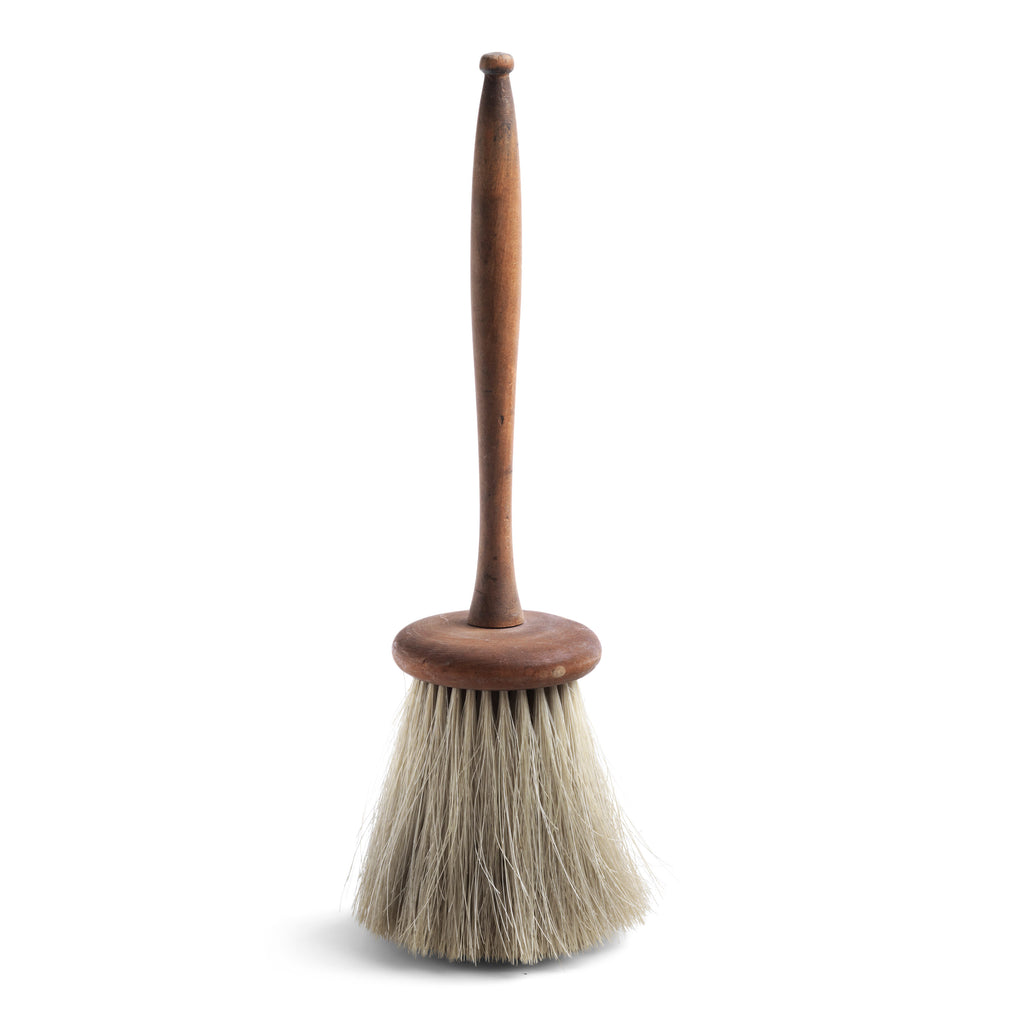 An elegant Edwardian dusting brush with a fine handcrafted beechwood turned handle and a soft hand-tufted horse hair head. It is not only a beautiful object of use, it is also a beautiful antique object in its own right - almost too good to use.