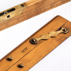 Carpenter's combined spirit level and inch rule: £45 L31cm W3.5cm Thickness 1cm; and a draughtsman's parallel rule with brass hinges and imprinted with "Universal Wood Working Co Ltd Made in England - Warranted Best Box": £58 Length 31cm Width 5.5cm Thickness 0.5cm