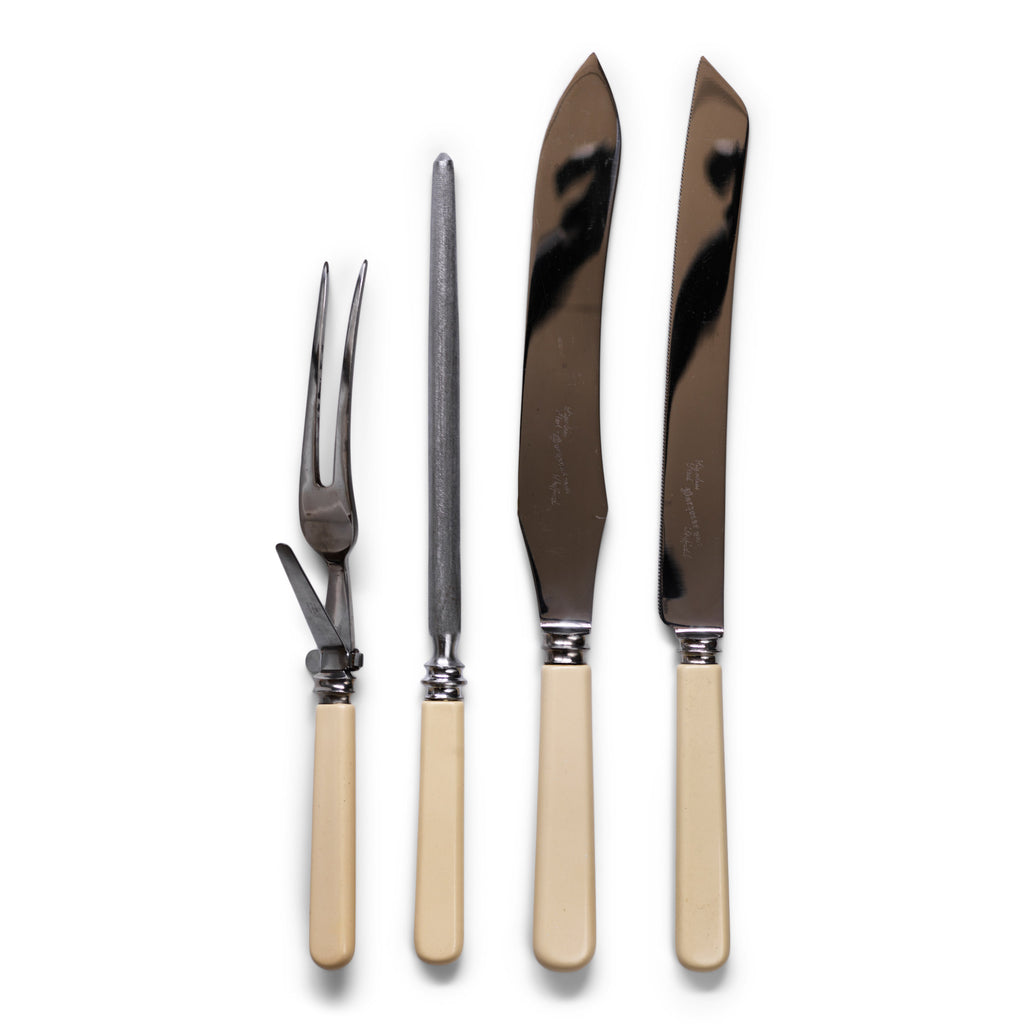 A four piece 'bone-handle' carving set by Margress of Sheffield, consisting of a carving knife and fork, a sharpening steel, and a matching bread knife.  And in such pristine condition, it looks like this set has never been used. Back in the day, it was marketed as "The Hygienic Carver Set", as it boasts a clip-on guard that can be detached from its carving fork to make cleaning after use easier.