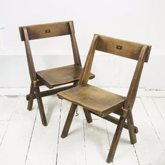 Very good-looking cricket pavilion chairs, each with a small enamel number affixed to its back (numbers 18 and 20). Each is beautifully constructed of solid beech and designed to fold flat when not in use, and so can easily be stored.