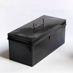 A handy little tin and of beautiful proportion retailed by the grand department store Gamages of London, and with its original black laquered paint finish. Inside the hinged lid is affixed an oval gold plaque embossed with “Trunk & Bag Department - A W Gamage Ltd, Holborn, London EC1”. It has a simple carrying handle and lock with original key.