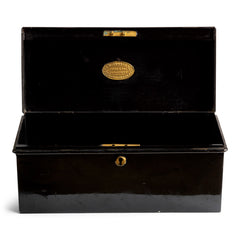 A handy little tin and of beautiful proportion retailed by the grand department store Gamages of London, and with its original black laquered paint finish. Inside the hinged lid is affixed an oval gold plaque embossed with “Trunk & Bag Department - A W Gamage Ltd, Holborn, London EC1”. It has a simple carrying handle and lock with original key.