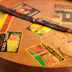 A very impressive Edwardian ply hat box with original luggage stickers, leather strap and cobalt blue interior. The stickers document the owner's grand tours of Italy and Egypt, from the Grand Hotel in Bologna to the Albergo Nazionale of Rome; and then in Egypt - the Hotel Cecil Alexandria, and the Luxor Winter Palace, to the Cataract Hotel of Assouan.