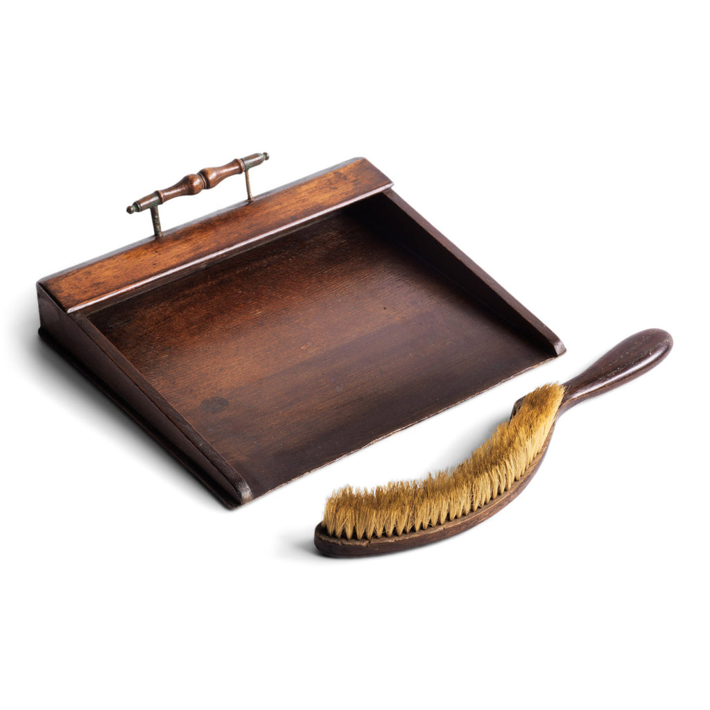 An Edwardian oak and plywood crumb tray with elegant brass handle; complete with its original matching curved crumb brush, crafted from oak and horsehair.