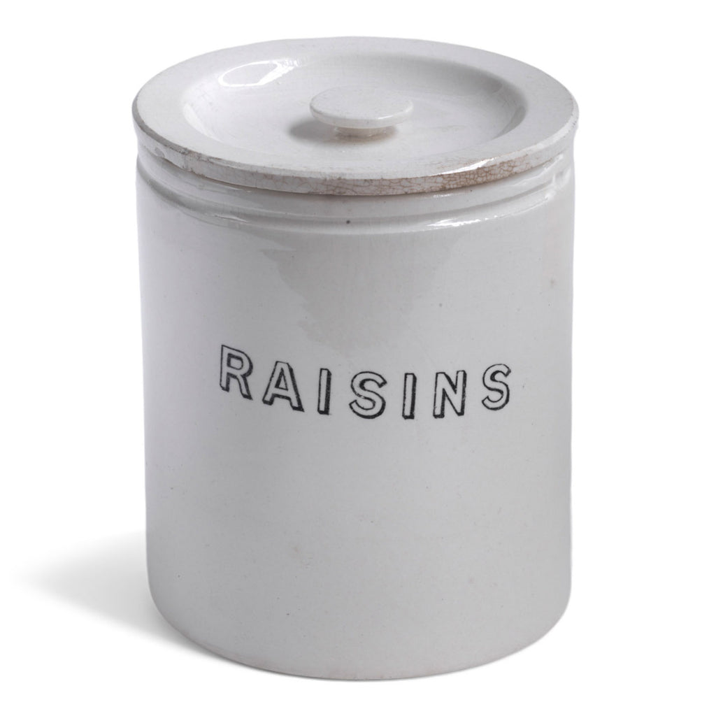 A handsome 1920s ironstone food canister with lid, banded body, and striking "Raisins" typeface.