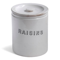 A handsome 1920s ironstone food canister with lid, banded body, and striking "Raisins" typeface.