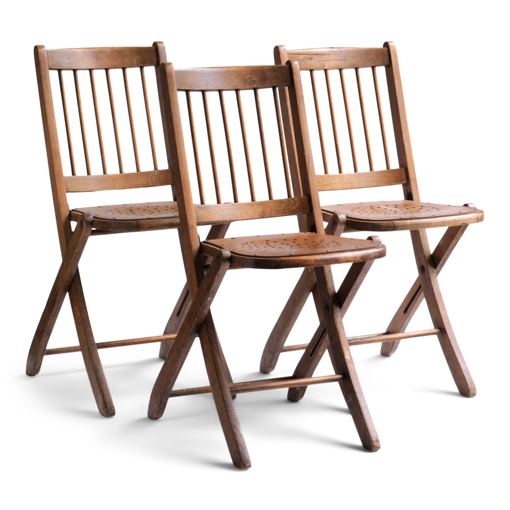 We have a run of these elegant Edwardian folding chairs, which were purchased some years back directly from the church hall in Winchelsea, East Sussex, UK. The seats are of ply with a pierced star pattern; the backs spindle slatted and each frame is beautifully constructed from solid walnut and designed to fold flat.