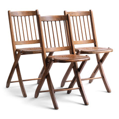 We have a run of these elegant Edwardian folding chairs, which were purchased some years back directly from the church hall in Winchelsea, East Sussex, UK. The seats are of ply with a pierced star pattern; the backs spindle slatted and each frame is beautifully constructed from solid walnut and designed to fold flat.