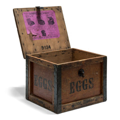 A 1920s egg travelling box, once used at Ewart Hebdish South Somerset Poultry Farm, Martock, Somerset, UK - as stamped on the lid. All four side panels and the lid are stencilled "Eggs", and various extra stamps, as shown in the images. It has a bracket hinged lid with carrying handle, reinforced metal trim corners, and a hasp. Inside the lid it still has its original maker's paper label, applied by the "Dairy Outfit Company Ltd, Kings Cross, London N1"