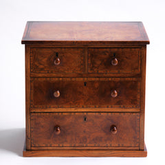 Our gorgeous early nineteenth century tabletop set of drawers are attributed to Gillows of Lancaster and comprise of two long and two short drawers, each retaining its original pair of turned wooden knobs. Veneered in figured walnut, cross-banded in exotic wood veneers and French polished, it is a stunner, and in wonderful condition. The two long drawers have brass locks with brass escutcheons, and the middle drawer contains divisions.