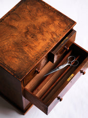 Our gorgeous early nineteenth century tabletop set of drawers are attributed to Gillows of Lancaster and comprise of two long and two short drawers, each retaining its original pair of turned wooden knobs. Veneered in figured walnut, cross-banded in exotic wood veneers and French polished, it is a stunner, and in wonderful condition. The two long drawers have brass locks with brass escutcheons, and the middle drawer contains divisions.