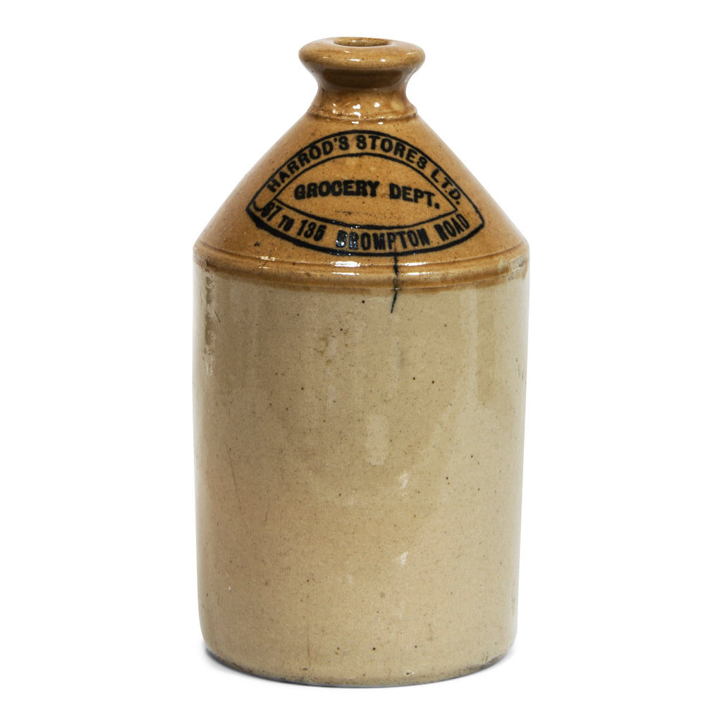 A Victorian Harrods department store flagon with strap handle and bold nineteenth century typeface: "Harrod's Stores Ltd Grocery Dept 87 to 135 Brompton Rd".