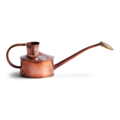 An elegant vintage Haws copper watering can, designed to be used in a greenhouse for watering seedlings or indoors for houseplants. The brass rose can be easily removed for more directional watering and is stamped "Haws Genuine". It still retains its original paper roundel that reads "The genuine Haws, Made in England", which is also stamped into the copper on the underside.
