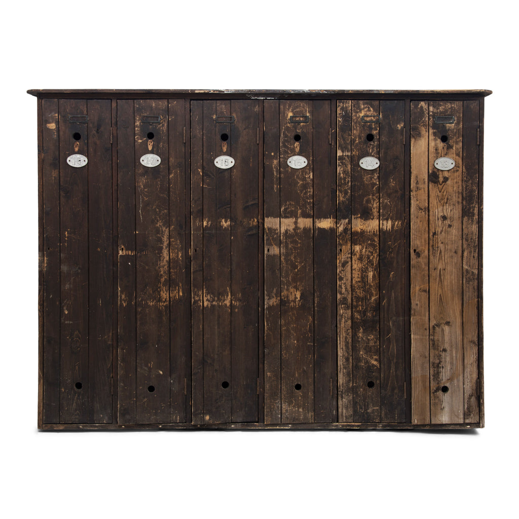 A magnificent bank of wooden lockers with original stained paint finish.  Each door is affixed with an oval aluminium numbered plate and name holder, and contains two circular air vents - top and bottom.  A grand looking and very handy storage solution for hallway, boot room or kitchen.