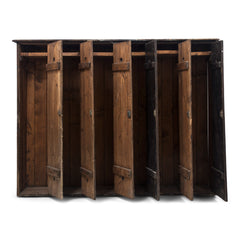 A magnificent bank of wooden lockers with original stained paint finish.  Each door is affixed with an oval aluminium numbered plate and name holder, and contains two circular air vents - top and bottom.  A grand looking and very handy storage solution for hallway, boot room or kitchen.