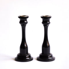 A striking pair of Edwardian ebony candlesticks