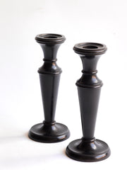 A striking pair of Edwardian ebony candlesticks.