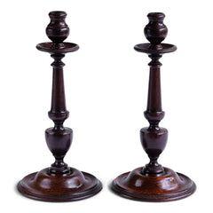 A magnificent large pair of 1920s turned dark stained oak candlesticks, complete with drip trays.