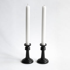 A handsome pair of Edwardian ebony candlesticks, their shape reminiscent of the castles in a game of chess.