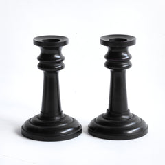A handsome pair of Edwardian ebony candlesticks, their shape reminiscent of the castles in a game of chess.