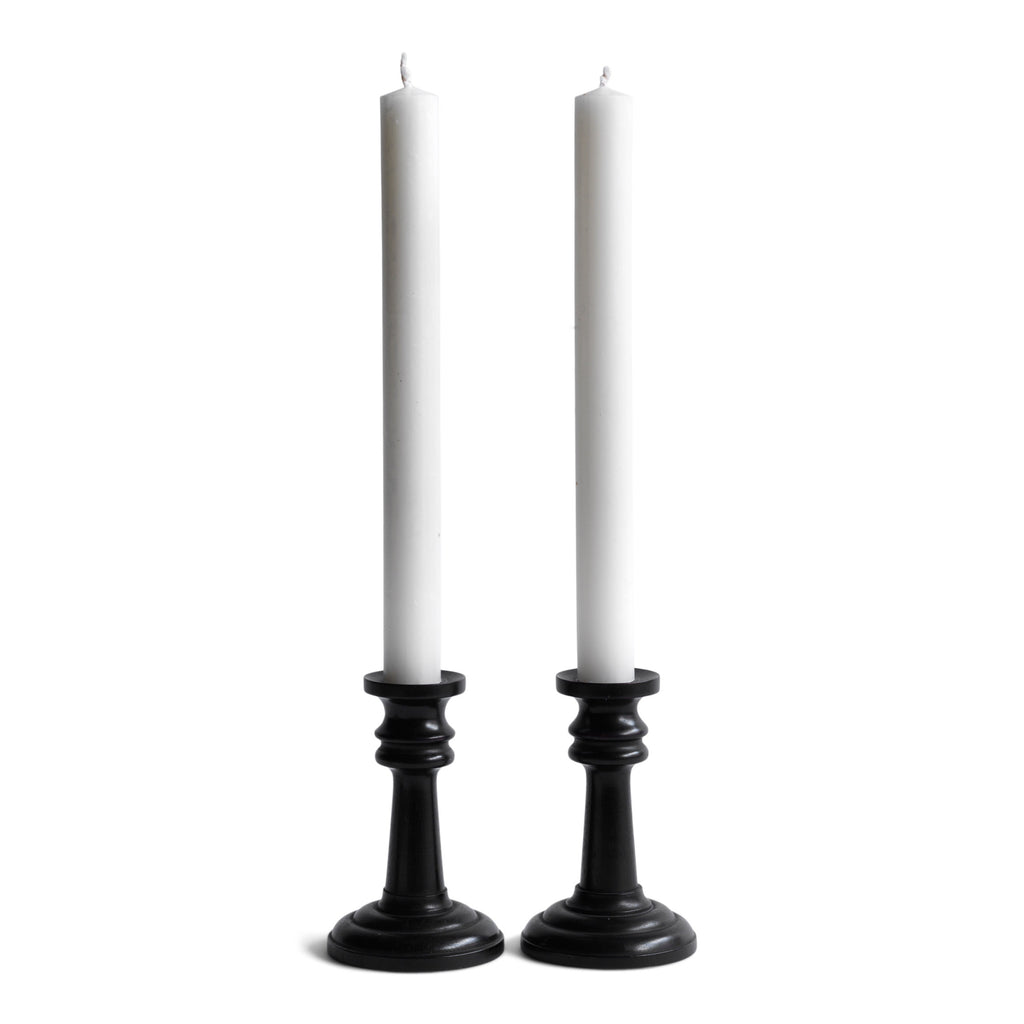 A handsome pair of Edwardian ebony candlesticks, their shape reminiscent of the castles in a game of chess.