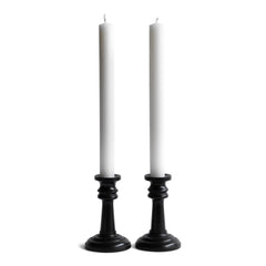 A handsome pair of Edwardian ebony candlesticks, their shape reminiscent of the castles in a game of chess.