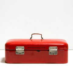 Back view of our striking scarlet red enamel bread box with hinged lid, carrying handle and fastening hasp. The hinges, handle and hasp are all nickel plated, and the interior of the box is finished in white enamel.