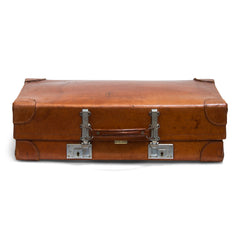 A good-looking expanding vintage leather 1940s suitcase with leather corners labelled "Revelation British Made". The revelation being this suitcase expands into the depth of a trunk, as the hinges and the front hasps elongate. A Prince of Wales feathers label inside the lid denotes it had Royal Appointment status. 