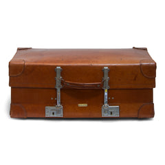 A good-looking expanding vintage leather 1940s suitcase with leather corners labelled "Revelation British Made". The revelation being this suitcase expands into the depth of a trunk, as the hinges and the front hasps elongate. A Prince of Wales feathers label inside the lid denotes it had Royal Appointment status.  This image shows the case expanded.