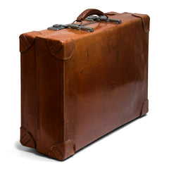A good-looking expanding vintage leather 1940s suitcase with leather corners labelled "Revelation British Made". The revelation being this suitcase expands into the depth of a trunk, as the hinges and the front hasps elongate. A Prince of Wales feathers label inside the lid denotes it had Royal Appointment status. 