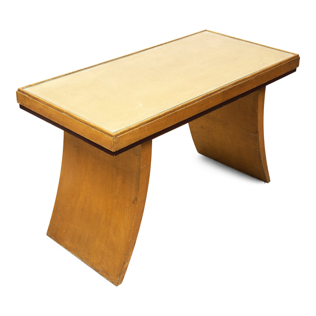 A rare and striking Art Deco occasional table that is purported to have once been part of the 1930s bedroom furniture at The Savoy Hotel, London. Finished in a satinwood veneer, the recessed top holds an inset rectangle of protective plate-glass within its frame.  Its gracefully tapered crescent-shaped legs are certainly in the style of past Art Deco furniture belonging to the hotel.