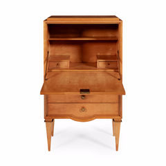 A stunning 1940s satin birch secrétaire attributed to André Arbus. The plain fall front opens to reveal a fitted interior above three drawers and square tapering legs with decorative brass capitals. The centralised demi-lune detail of the lower drawer facade; the exaggerated taper of the squared legs, and their decorative brass capitals, are all hallmark Arbus design details and characteristic of the designer's peak, his 1940s "neoclassique" period.