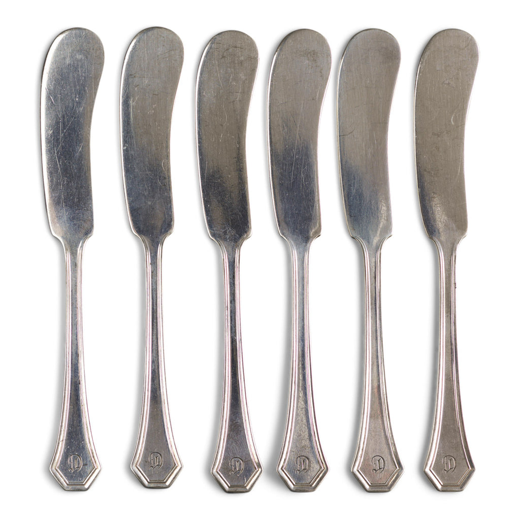A good set of 6 vintage hotel ware silver-plated butter knives with a "D" monogram. These well designed butter knives have silver plated blades and silver-plated handles, and are a joy to use. They are just the ticket for spreading butter, as their blade is broad and slightly curved.