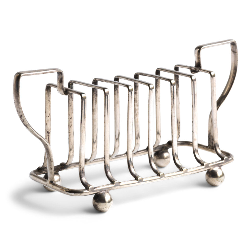 An Edwardian twin handled silver plated toast rack with ball feet.