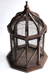 A very elegant Victorian architectural cupola shaped bird cage with original wiring and painted finish. The base is constructed from wood and supports eight wooden columns which in turn anchor the fine wire cage work - and its dome is topped with a turned finial. The cage is also fitted with a sprung wire hatch for access, and a base that is hinged for cleaning purposes.