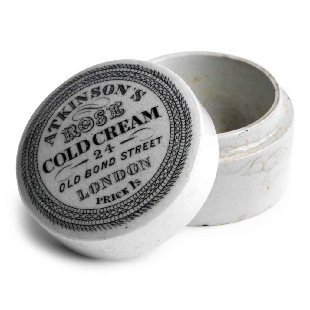 The lid of this cold cream pot is exquisitely designed and bears all of the proprietor's information in black and white: "Atkinson's Rose Cold Cream - 24 Old Bond London - Price 1s" with "Too Good Patent London" on the underside.