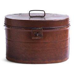 A handsome Victorian hat tin with hinged lid, carrying handle, hasp, and original pecan brown painted finish. The interior paint is also original and is a steely Prussian blue. It has a wonderful polished and buffed patina, built from its 130 years of travels.