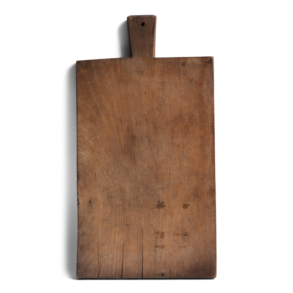 A rustic antique vintage chopping board with a time-worn, knife-cut patina, full of character and warmth.