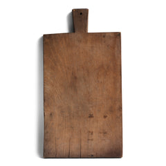 A rustic antique vintage chopping board with a time-worn, knife-cut patina, full of character and warmth.