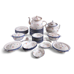 A wonderful, rare antique doll's enamel dinner service decorated with rose buds and leaf sprigs, and each piece finished with a blue trim; very much in tune with the current trend "cottage core", an aesthetic which celebrates an idealised rural life. This is part of an extensive collection of miniature enamel kitchen ware, previously owned by the late miniaturist specialist and collector extraordinaire Joan Dunk.