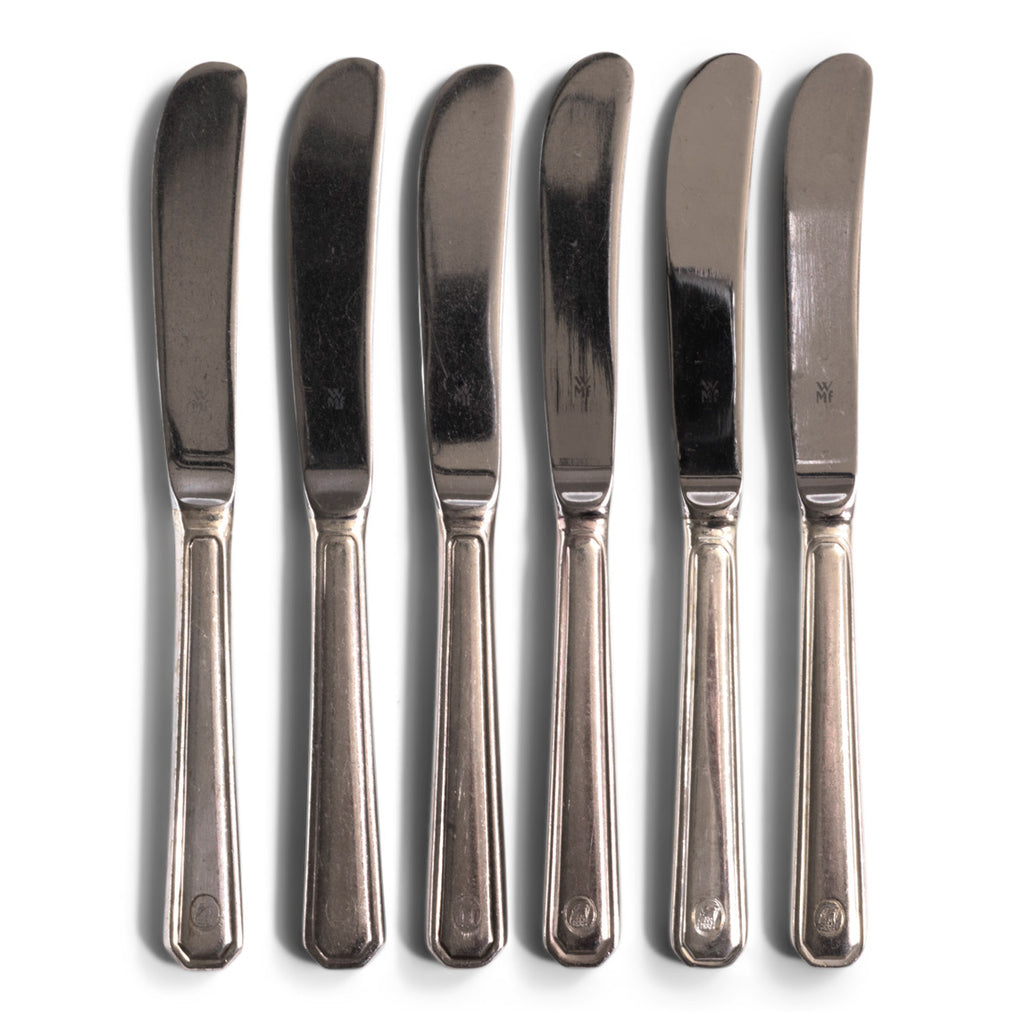 Vintage hotel ware silver-plated WMF butter knife, made for Holland & America Line, the cruise liner company. Each is marked WMF and the tip of the fork handles bear the hallmark Holland & America circular crest, the Art Deco stylised prow of a large transatlantic steamship.
