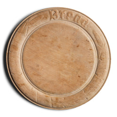 A Victorian bread board carved with traces of stylised wheat-sheaf motifs, along with "Bread" carved on its border. The board has been much loved, has a wonderful polished patina, and the wheat-sheafs are now but ghosts in the wood.
