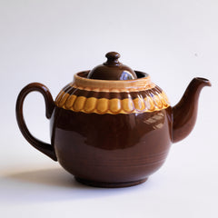 A good large 6 cup original Brown Betty teapot with mustard banding and raised pie-crust style fluting.