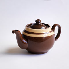 A charming little vintage Brown Betty teapot with two cream coloured bands.